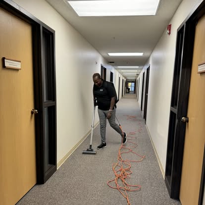 Buay Cleaning vacuuming a commercial hallway